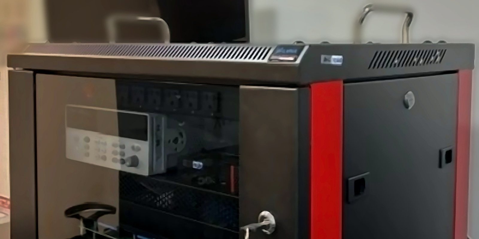 Closed ALVNA test unit with red trim, roof mounted handles, and a locking front panel